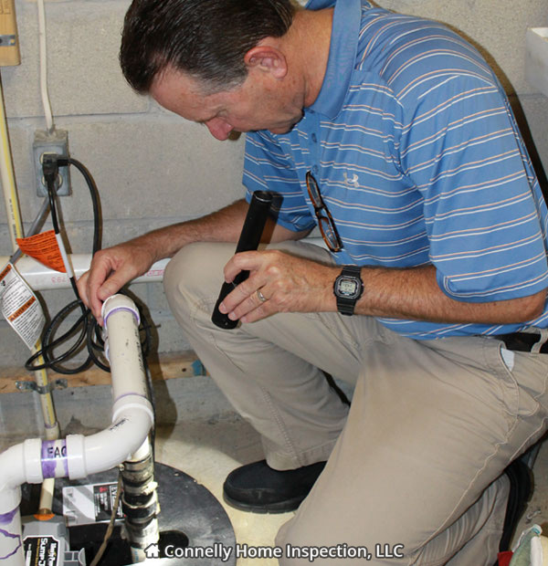 Inspecting Sump Pump during home inspection